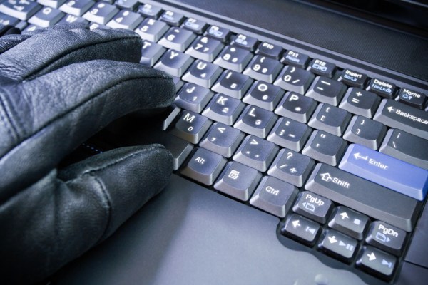 Computer hacker working on laptop