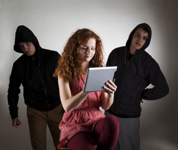 Concept of potential internet danger with teen girl and man in disguise