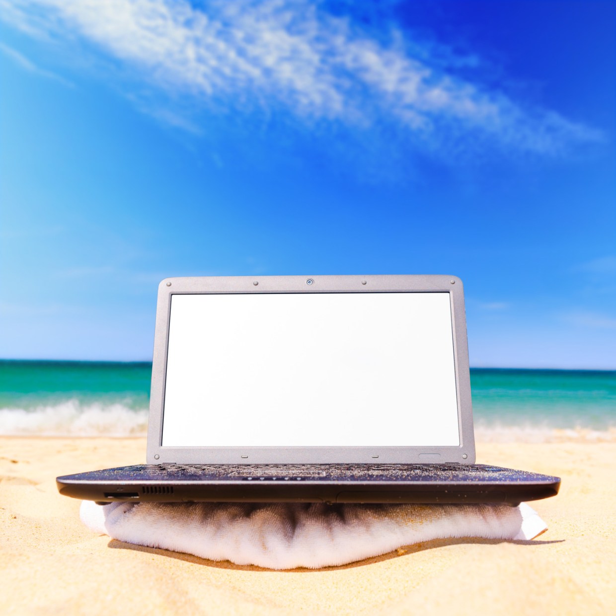 modern laptop with blank screen on beach