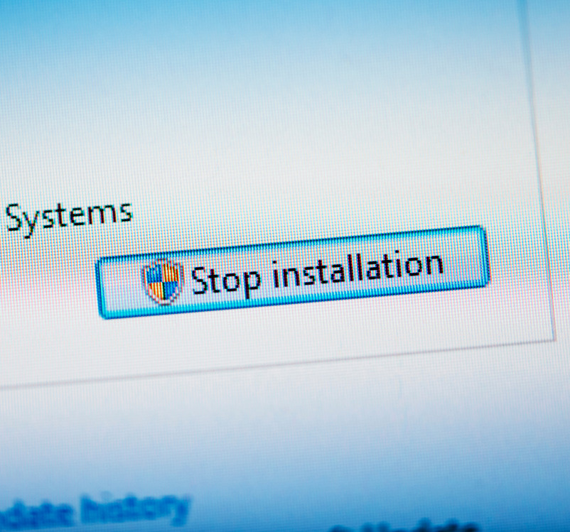 Stop installation button on computer display.Tilt-shift lens used to outline the button  and to emphasize the attention on it