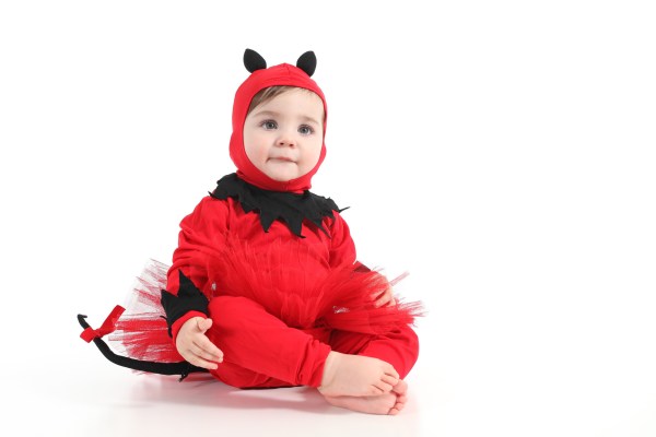 Baby with a red demon disguise  on a white isolated background