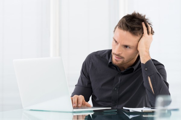 Stressed Man Working On Laptop