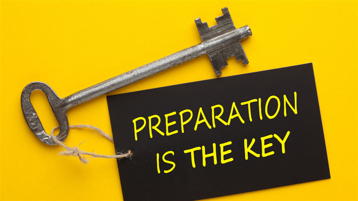 key with text preparation is key on yellow background
