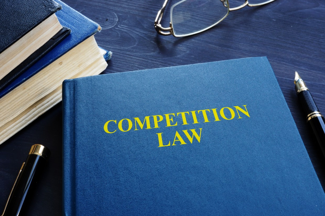 Competition law and pen on a table.