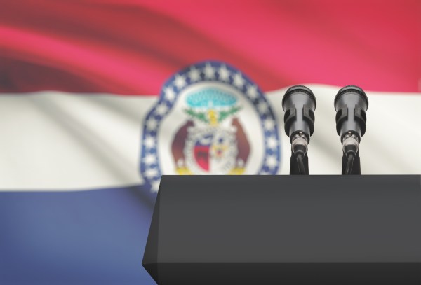 Pulpit and two microphones with US state flag on background - Missouri