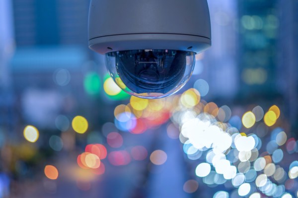 CCTV overhead for security on the road or in town and with soft car and building background.