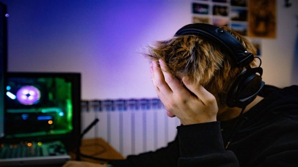 Young Boy Facepalming After Losing in Video Game