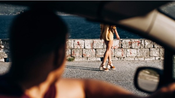 Man in car stalking a young woman