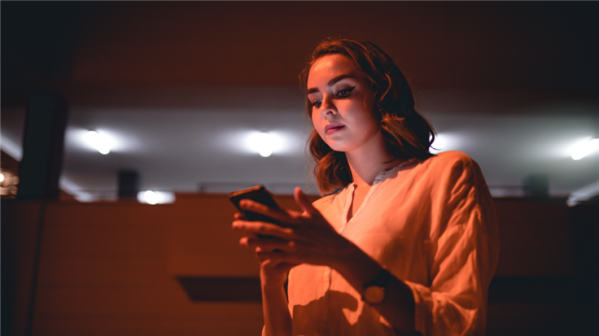 woman looking at phone serious