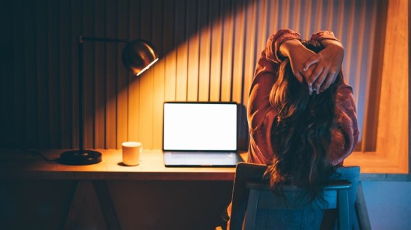 Fatigued looking woman in front of a computer