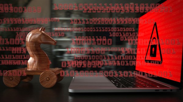 wooden Trojan horse against laptop