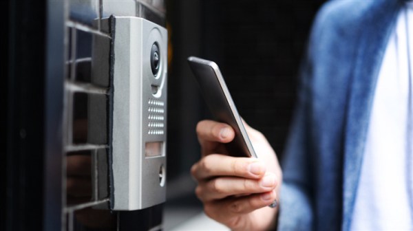 Person holding a phone for a door lock