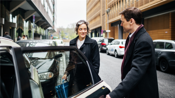 man politely opening car door for a woman