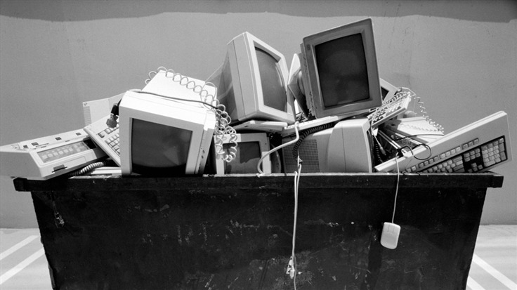 Office computers in a trash heap