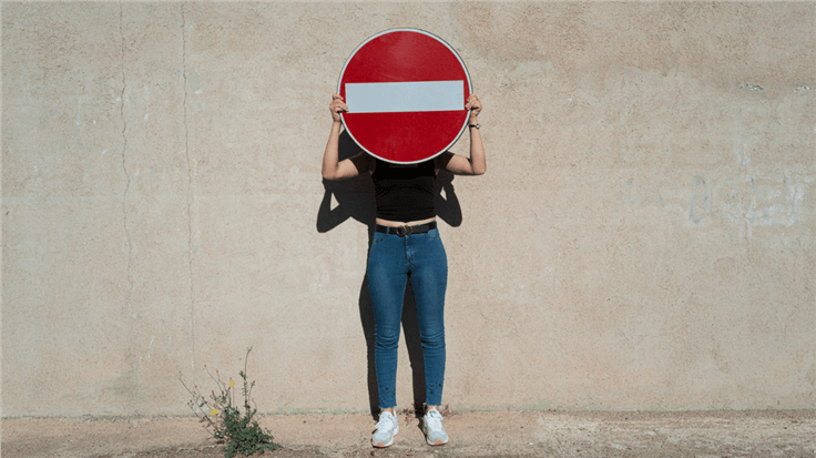 Woman with stop sign in front of face