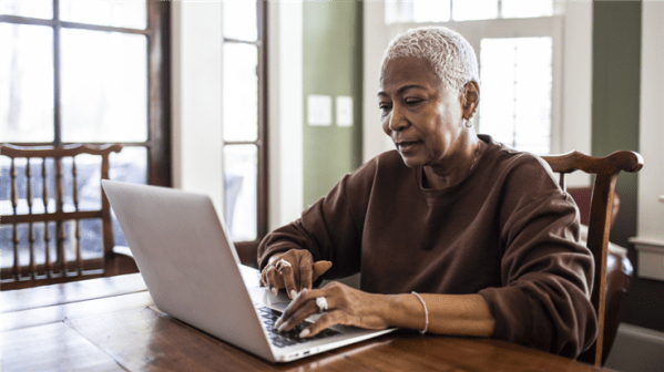 grey haired lady working on a laptop
