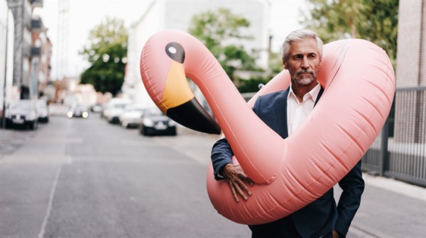 Man with an inflatable flamingo