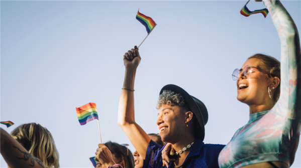 People waving rainbow flags