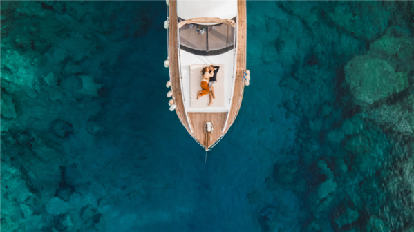 Boat with two people relaxing on the deck