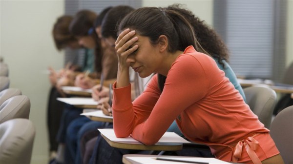 Girl holding her head in her hand looking frustrated