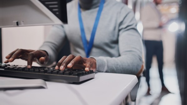 Closeup shot of a man working at a computer keyboard