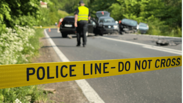 Police tape across the scene of a car accident