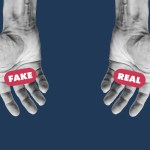 Two hands that look identical have the words "Fake" written over the left hand and "Real" written over the right hand