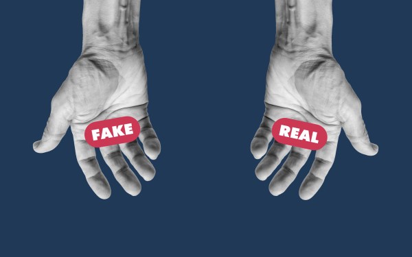 Two hands that look identical have the words "Fake" written over the left hand and "Real" written over the right hand