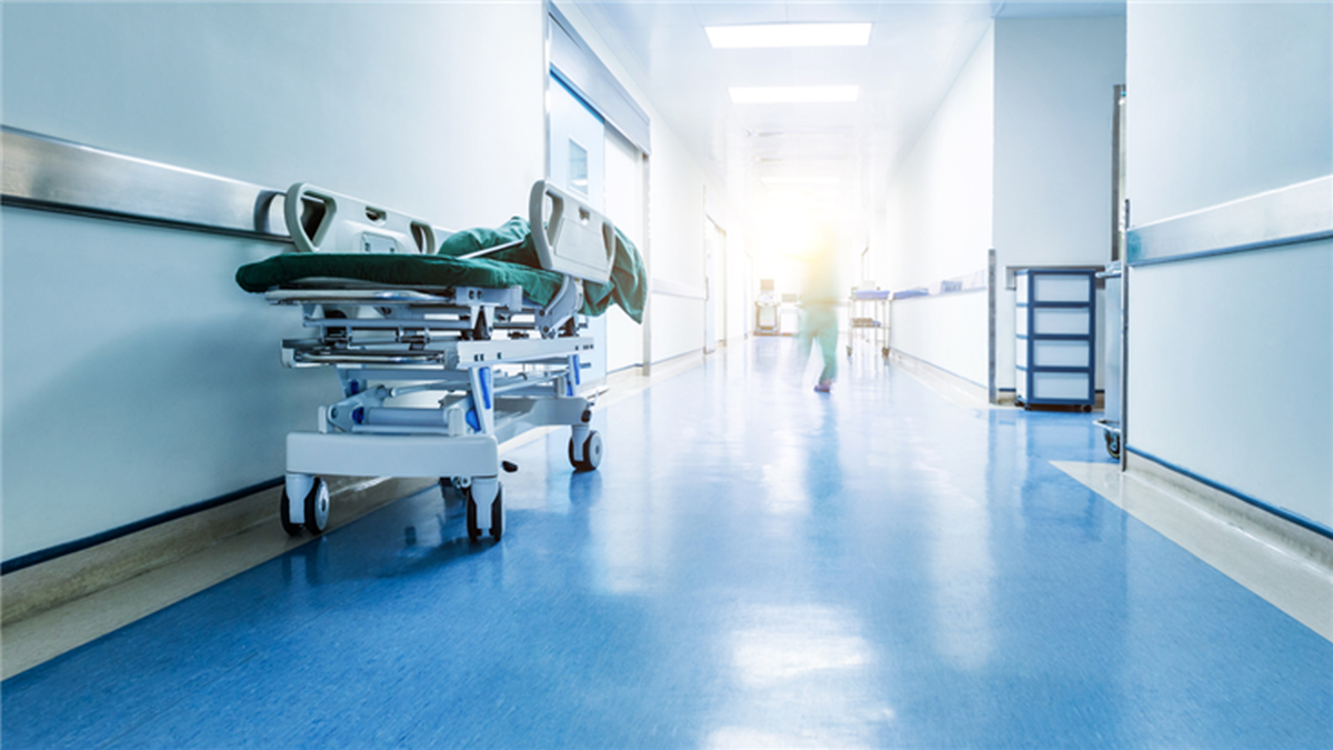 healthcare image, a bed in an empty hospital hallway