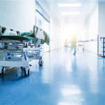 healthcare image, a bed in an empty hospital hallway
