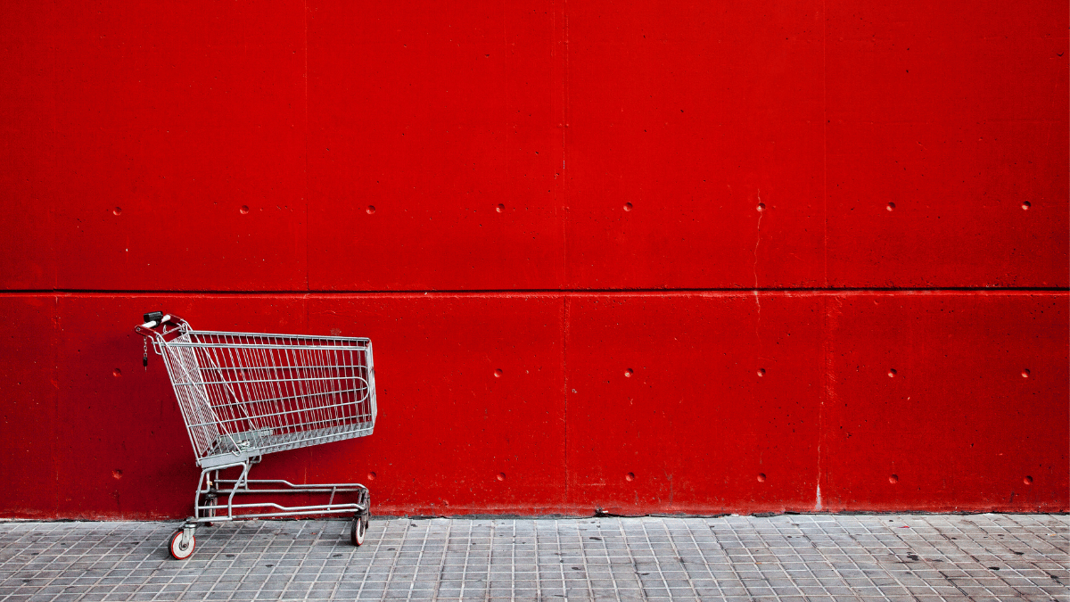 An empty trolley in front of a red wall