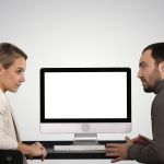 man and woman sharing a Mac