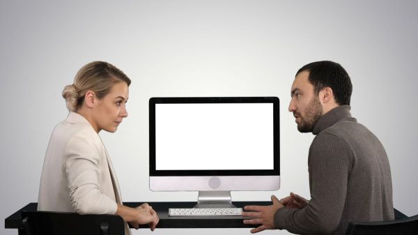 man and woman sharing a Mac