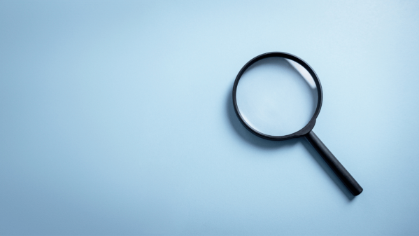 A magnifying glass on a blue background.