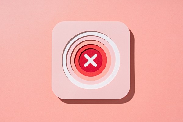 A bright "X" is placed at the center of red, concentric circles, which are inside a pink square