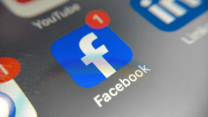 Facebook icon on a mobile phone screen
