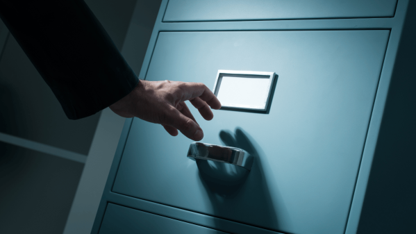 Man trying to open a filing cabinet