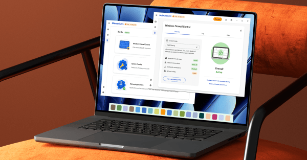 Image of an open laptop sitting on a sofa with the Malwarebytes dashboard on screen