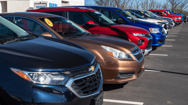 A line of different cars in a parking lot