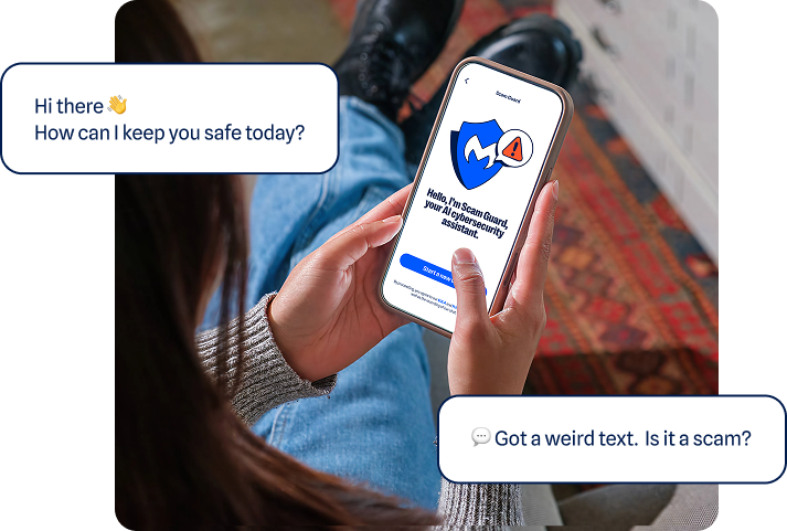 Photo pg person holding a phone with Scam Guard on the screen