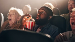 Eating popcorn and watching something shocking