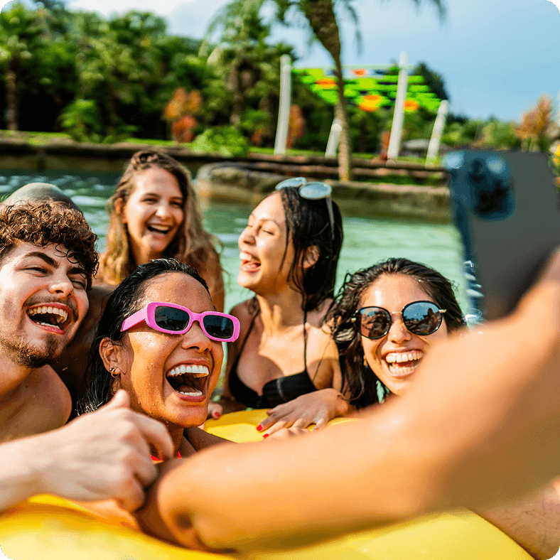Group of friends in a pool taking a selfie during the summer